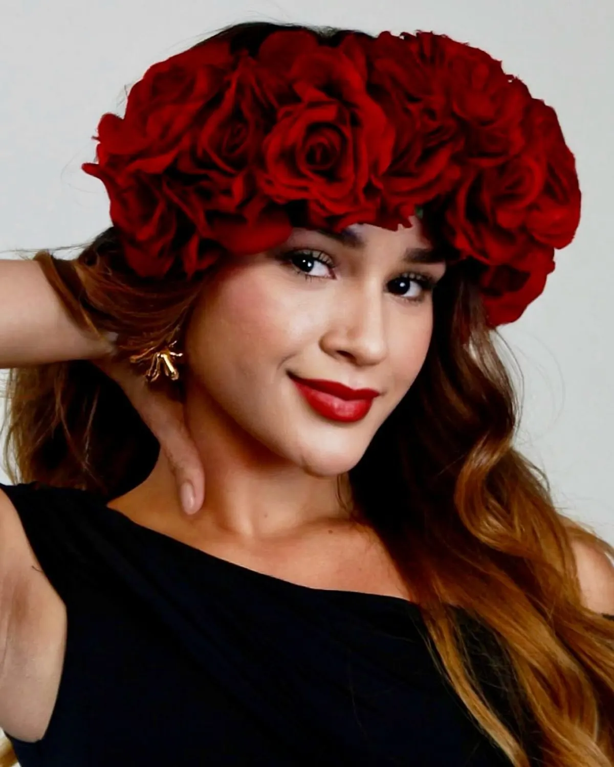 A candidate in a crown of red roses smiling at the camera